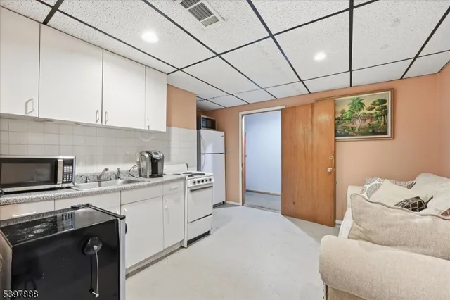 a kitchen with stainless steel appliances kitchen island granite countertop a sink stove and refrigerator