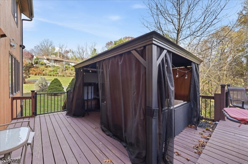 1605 Justin Place, Unit 1 Mountainside, NJ 07092 - Photo 6 of 43 a view of a wooden house with a large window and wooden fence