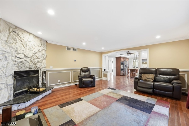 1605 Justin Place, Unit 1 Mountainside, NJ 07092 - Photo 9 of 43 a living room with furniture a flat screen tv and a fireplace