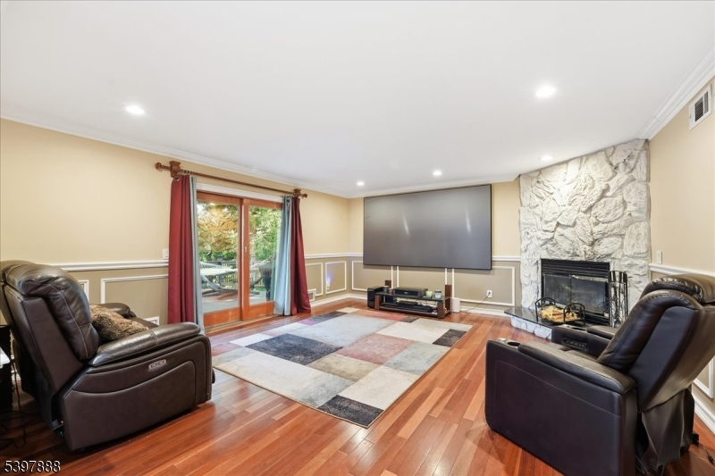 1605 Justin Place, Unit 1 Mountainside, NJ 07092 - Photo 10 of 43 a living room with furniture a fireplace and a flat screen tv