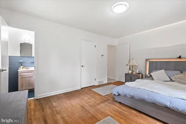 a bedroom with a bed and a sink