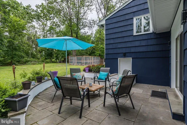 a view of backyard of house with seating space