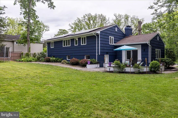 a view of a house with a yard patio and fire pit