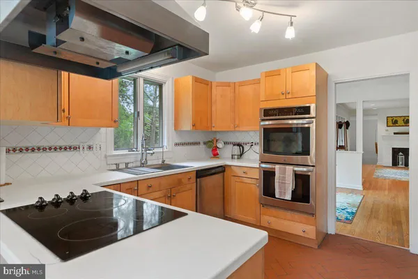 a kitchen that has a sink and a stove top oven