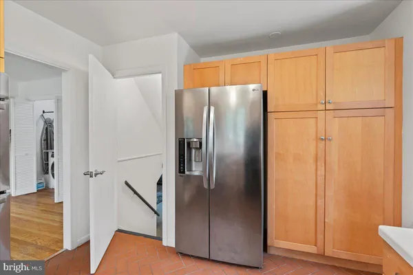 a metallic refrigerator freezer sitting in a kitchen