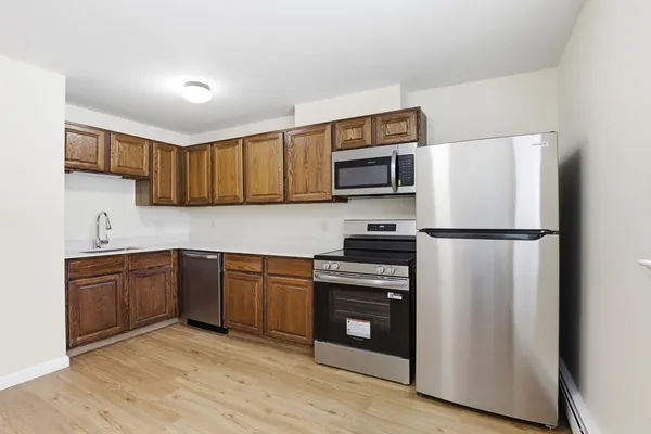 a kitchen with stainless steel appliances granite countertop a refrigerator stove and sink