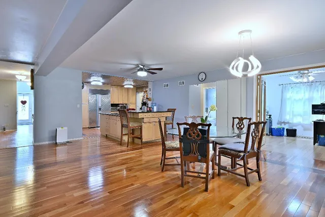 a view of a dining room with furniture and wooden floor