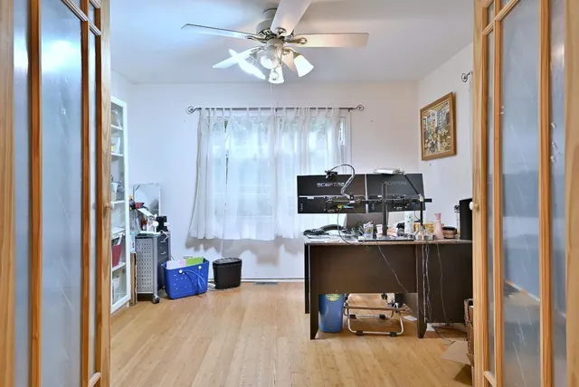 a view of a workspace with furniture and a window