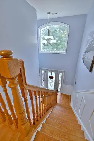 a view of a bedroom with wooden floor and staircase