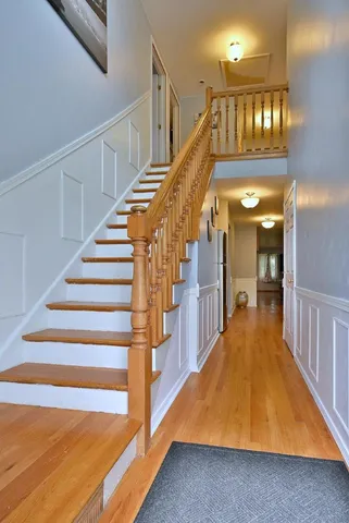 a view of entryway and hall with wooden floor