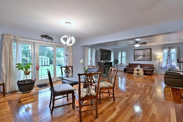 a view of a dining room with furniture window and wooden floor