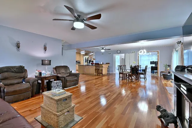 a living room with furniture and wooden floor