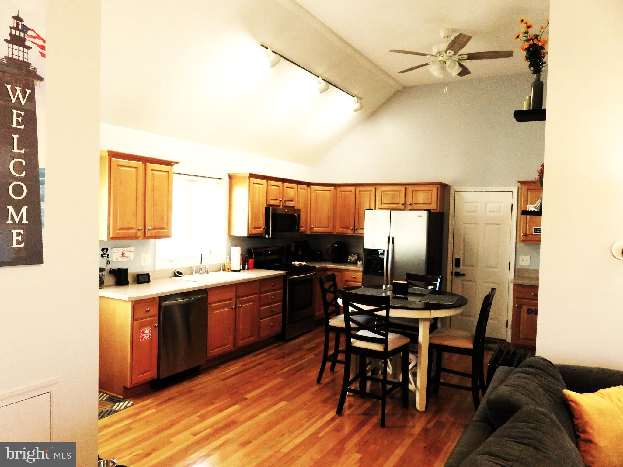 28 Bryan Drive Rehoboth Beach, DE 19971 - Photo 15 of 41 a view of a dining room with furniture window and wooden floor