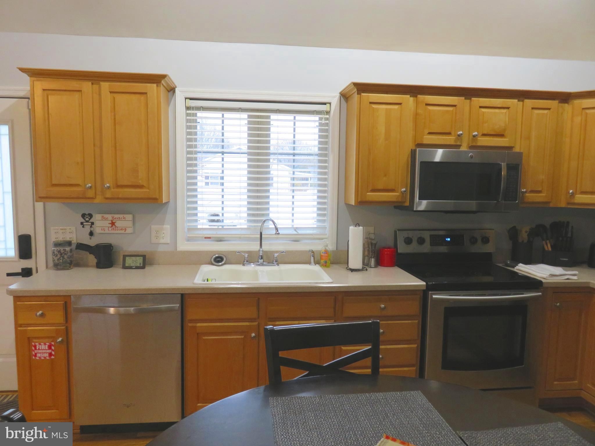 28 Bryan Drive Rehoboth Beach, DE 19971 - Photo 16 of 41 a kitchen with a sink stove and microwave
