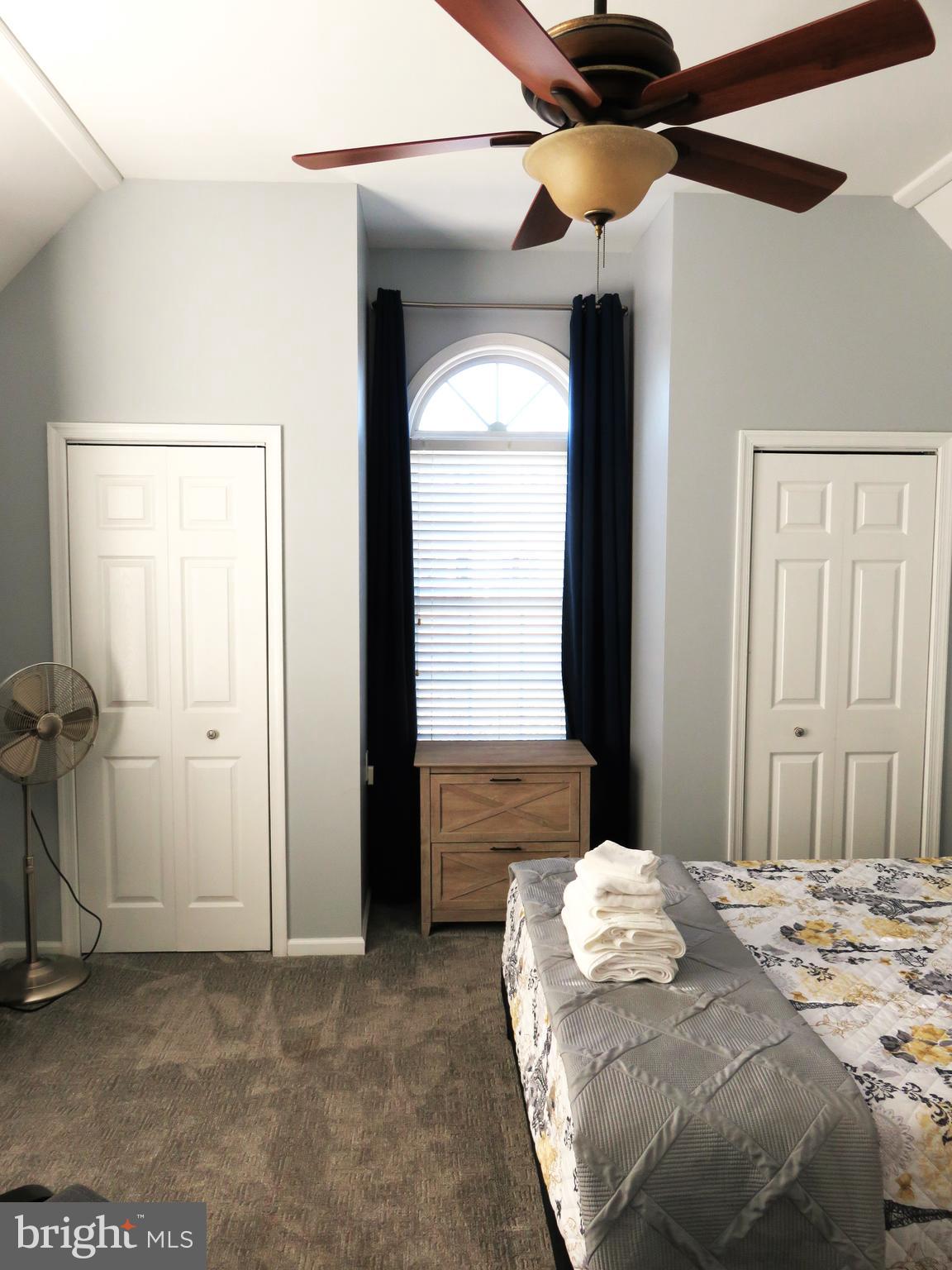 28 Bryan Drive Rehoboth Beach, DE 19971 - Photo 20 of 41 a bedroom with a bed and a chandelier