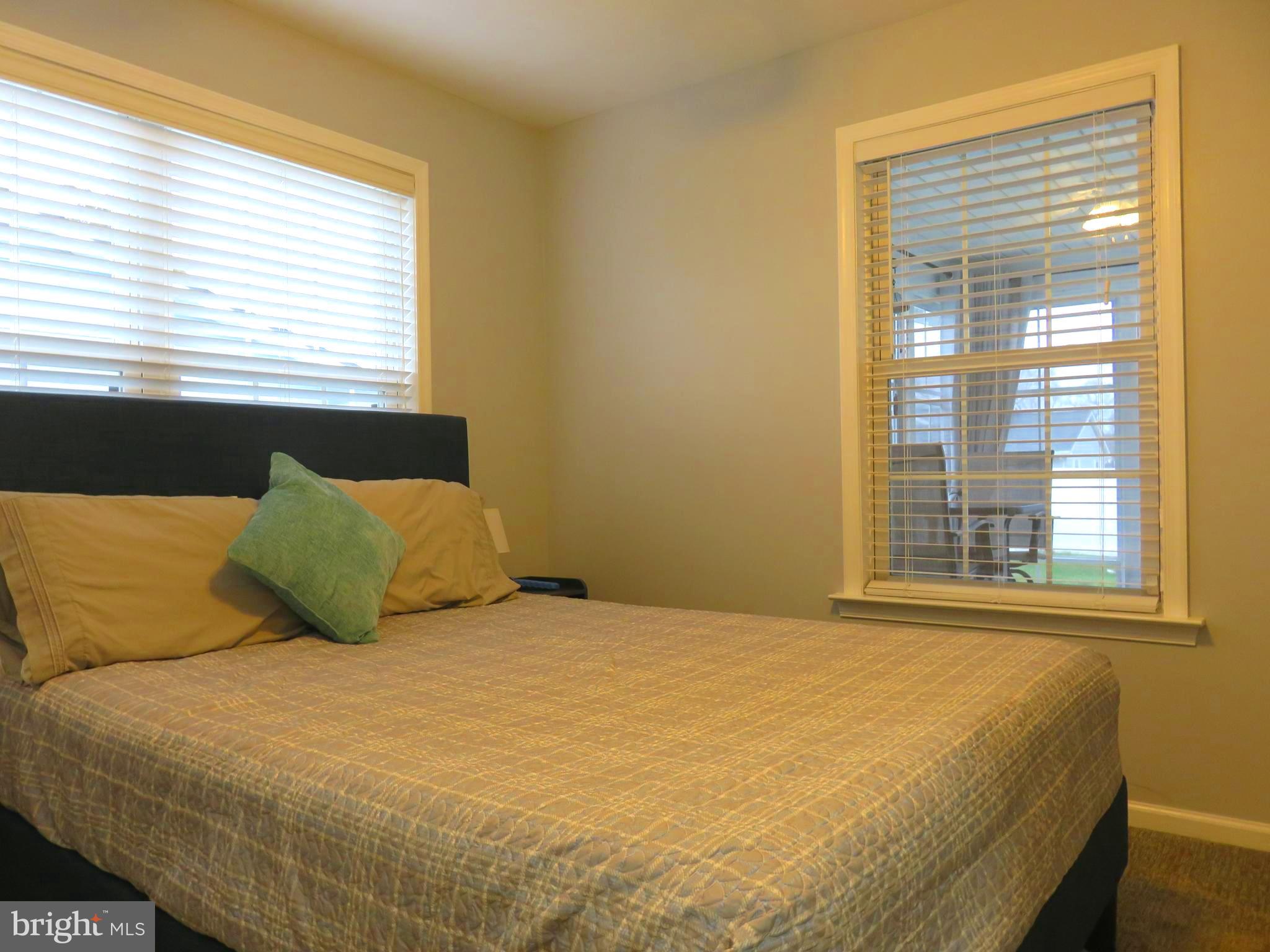 28 Bryan Drive Rehoboth Beach, DE 19971 - Photo 28 of 41 a large bed sitting in a bedroom next to a window