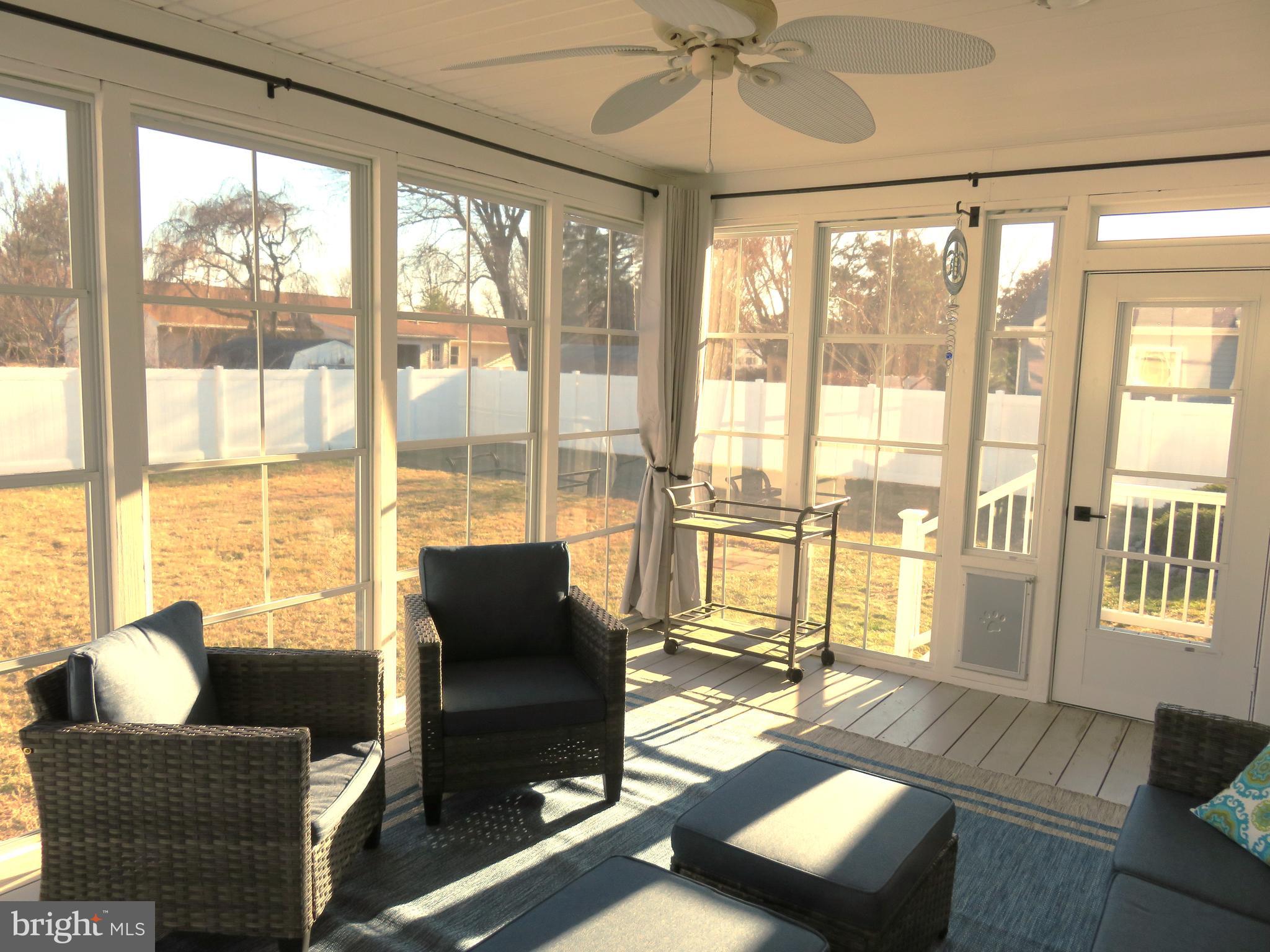 28 Bryan Drive Rehoboth Beach, DE 19971 - Photo 34 of 41 a living room with furniture and floor to ceiling windows