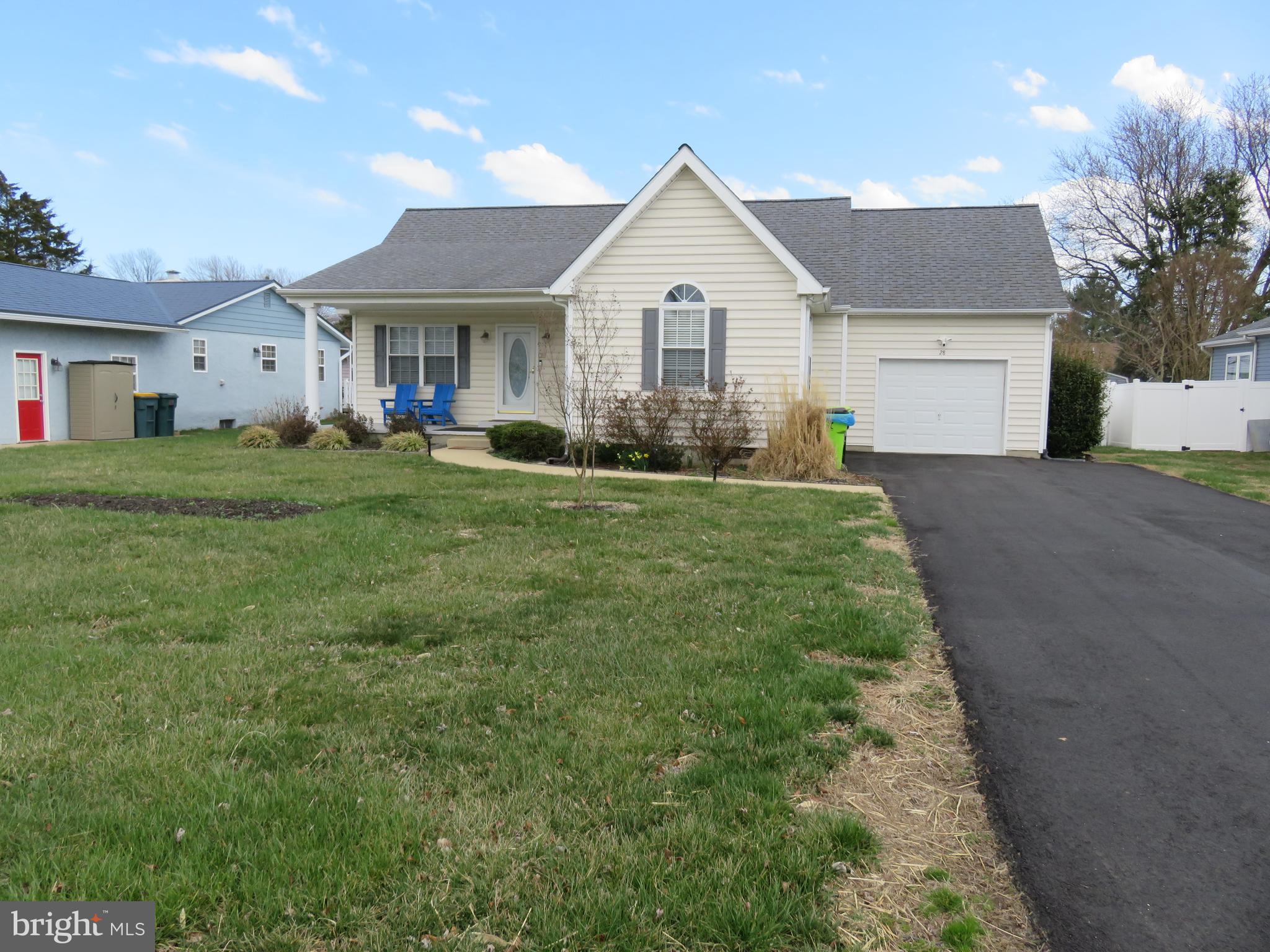 28 Bryan Drive Rehoboth Beach, DE 19971 - Photo 40 of 41 a front view of a house with a yard and garage