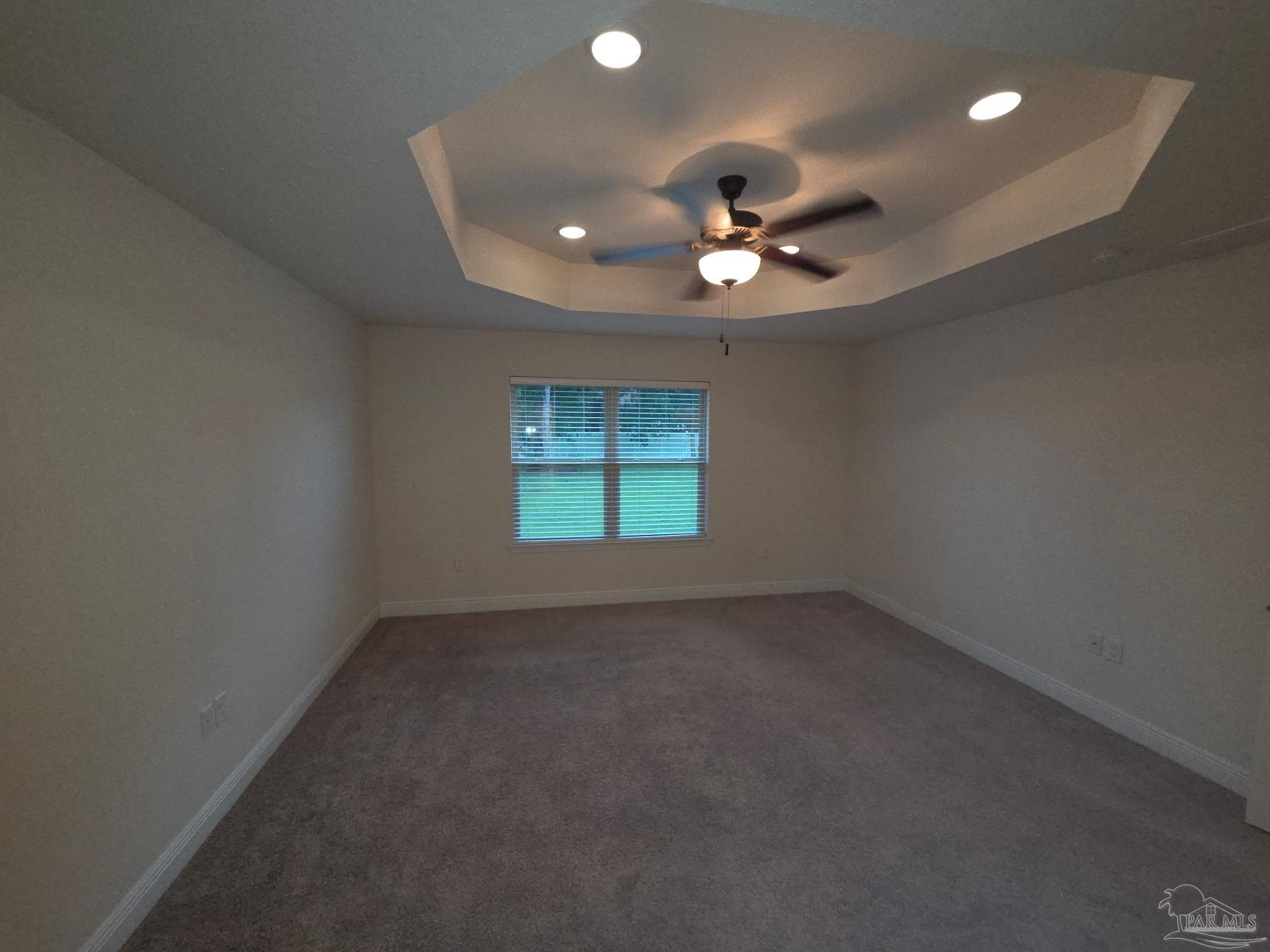 5709 Mill Stream Way Pace, FL 32571 - Photo 3 of 48 an empty room with a window and a ceiling fan