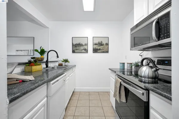a kitchen with a sink a stove and cabinets