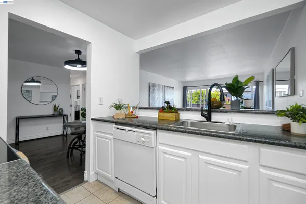 a kitchen with sink and cabinets
