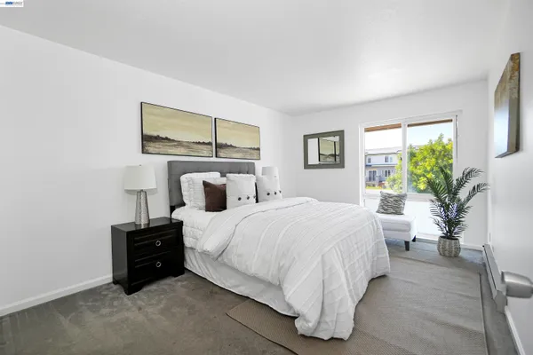 a bedroom with a bed and a potted plant