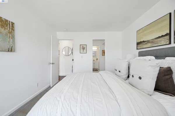 a bedroom with a bed and a large mirror