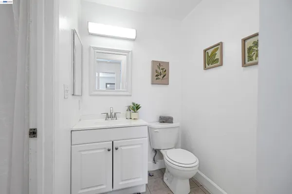 a white toilet sitting next to a bathroom sink