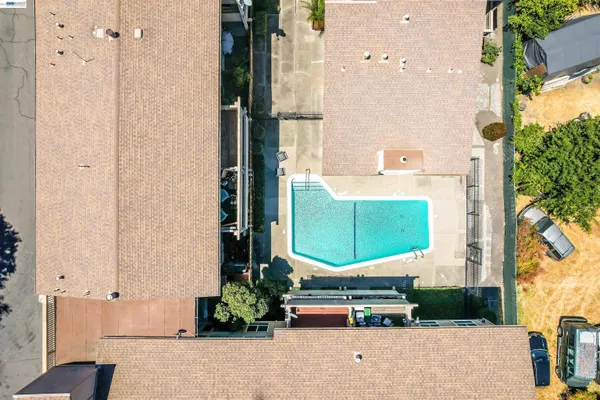 an aerial view of a residential apartment building with a yard