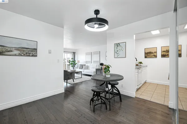 a view of a livingroom and dining room with wooden floor