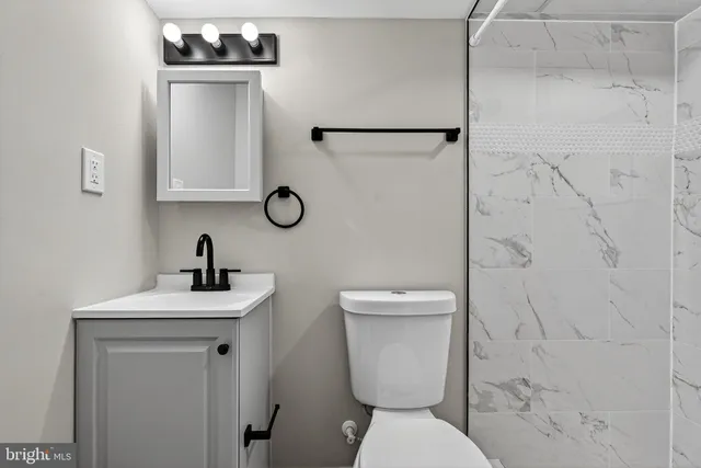a bathroom with a toilet sink and shower