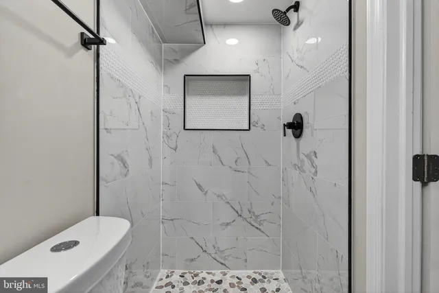 a bathroom with a shower toilet and sink
