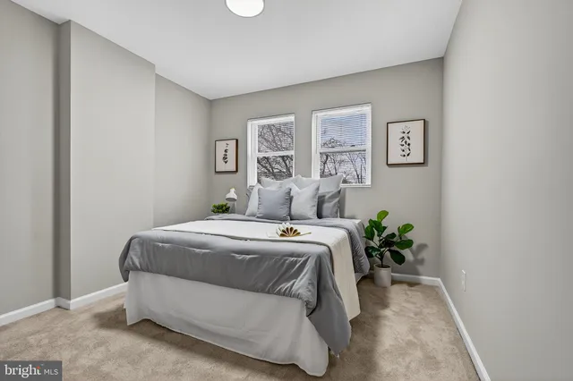 a bedroom with a bed and a potted plant