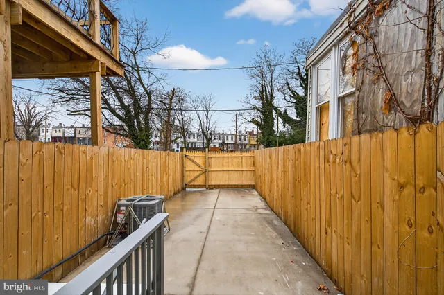 a view of a pathway covered with wooden fence