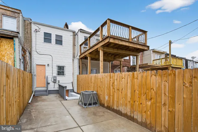 a view of a house with wooden fence