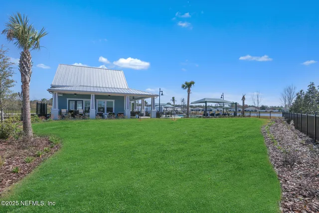 a view of a house with a backyard and a patio