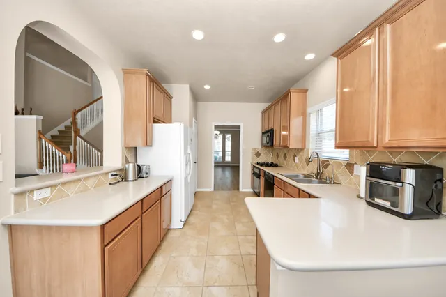 a large white kitchen with a large window