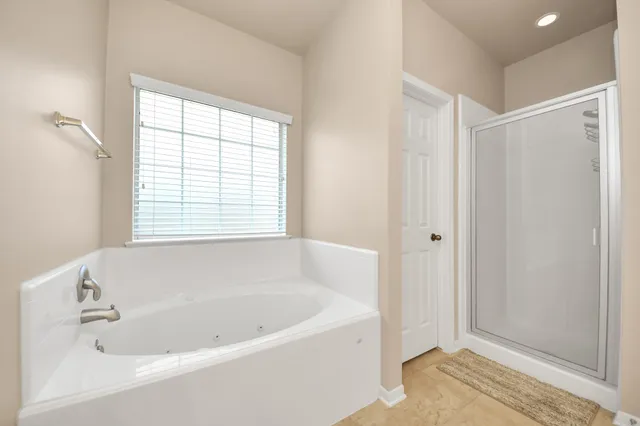 a white bath tub sitting next to a window