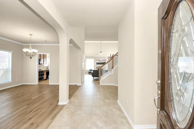 a view of interior and hallway with wooden floor