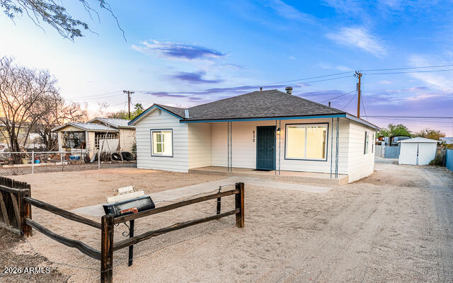 a view of a house with a wooden fence