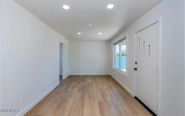 a view of a room with wooden floor and window