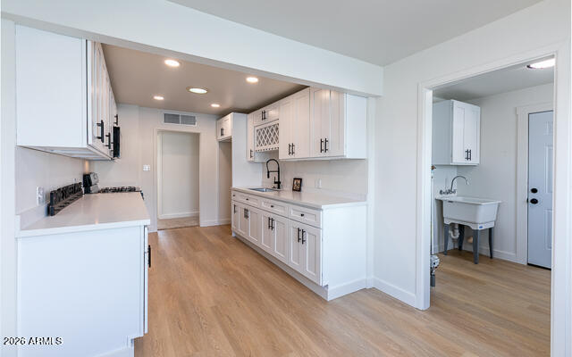 630 Solana Avenue Ajo, AZ 85321 - Photo 19 of 41 a kitchen with a white stove top oven and cabinets