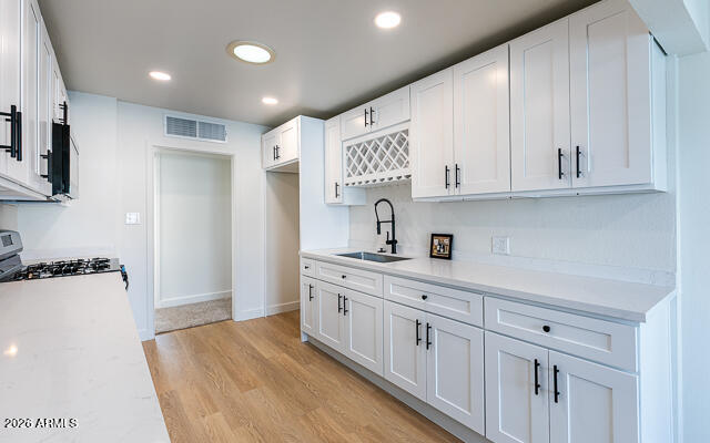 630 Solana Avenue Ajo, AZ 85321 - Photo 21 of 41 a kitchen with white cabinets and sink
