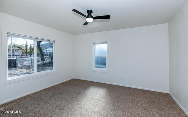 630 Solana Avenue Ajo, AZ 85321 - Photo 22 of 41 an empty room with ceiling fan and windows