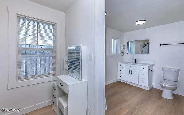 a bathroom with a toilet sink and mirror
