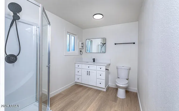 a spacious bathroom with a granite countertop toilet sink and a mirror