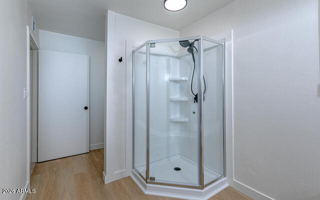 630 Solana Avenue Ajo, AZ 85321 - Photo 31 of 41 a bathroom with a glass shower door and a window