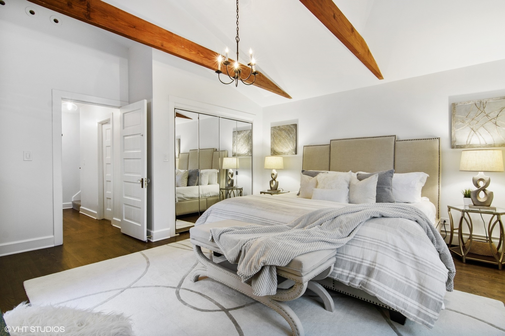 628 Abbotsford Road Kenilworth, IL 60043 - Photo 26 of 48 a bedroom with a large bed and a chandelier