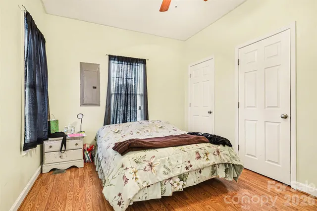 a bedroom with a bed and a mirror