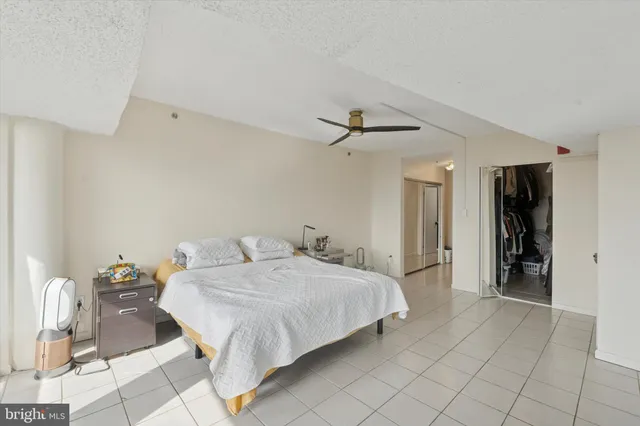 a bedroom with a bed and cabinets